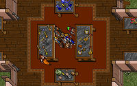 Screenshot from Ultima VII of the party of adventurers standing in a hall surrounded by tables with artistic artifacts on them, such as musical instruments, pottery and other crafts.