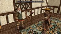 Screenshot from Ultima IX of a balding, white-haired, white-bearded man speaking with an armoured man in a room with a harp