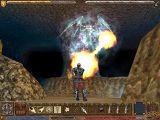 Screenshot of Ultima IX UI in a cavern depicting a flame being hurled at an enemy.