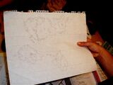 A photograph of a sketch of a physical map of fictitious lands including a few continents and several islands.