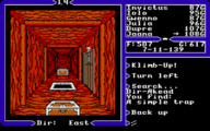 A screenshot from Ultima V depicting 2 chests lying on the floor of a dungeon corridor. A hole appears between them and the door can be seen to the right.