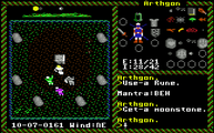 A screenshot from the C64 version of Ultima VI, depicting 4 party members, outdoors, in front of a stone table surrounded by a semi-circle of stones.